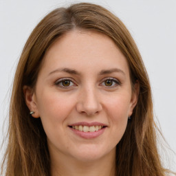 Joyful white young-adult female with long  brown hair and green eyes