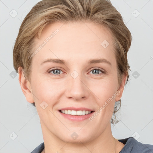 Joyful white young-adult female with medium  brown hair and grey eyes