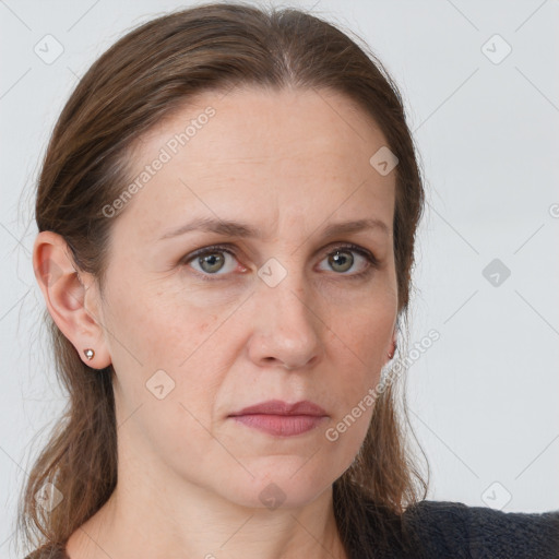 Joyful white adult female with long  brown hair and grey eyes