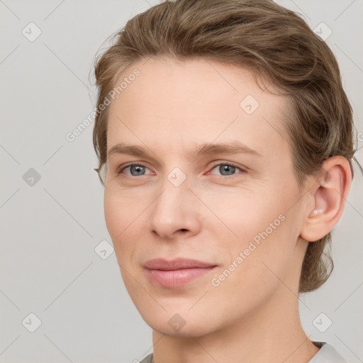 Joyful white young-adult female with short  brown hair and grey eyes