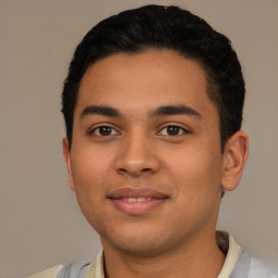 Joyful latino young-adult male with short  black hair and brown eyes