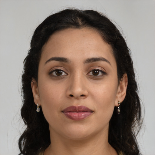 Joyful latino young-adult female with medium  brown hair and brown eyes