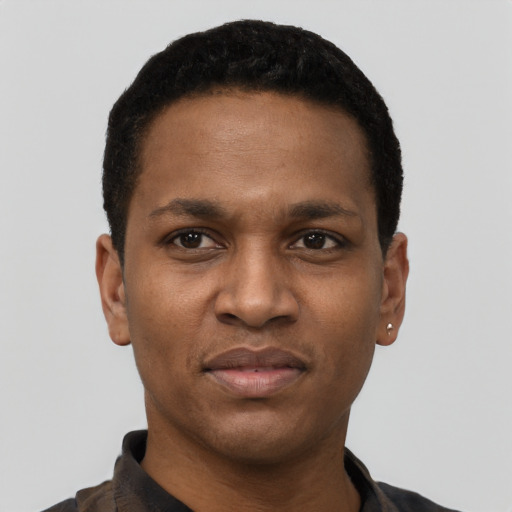 Joyful black young-adult male with short  black hair and brown eyes