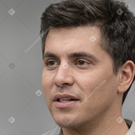 Joyful white young-adult male with short  black hair and brown eyes