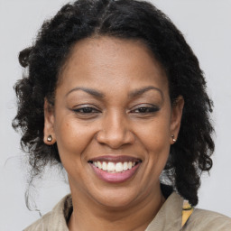 Joyful black adult female with medium  brown hair and brown eyes