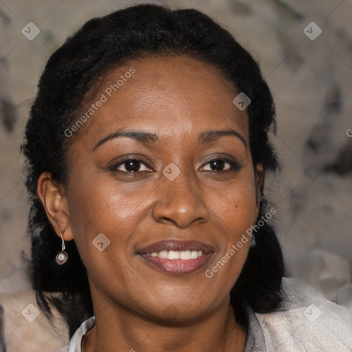 Joyful black adult female with medium  brown hair and brown eyes