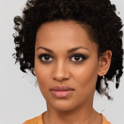 Joyful black young-adult female with medium  brown hair and brown eyes