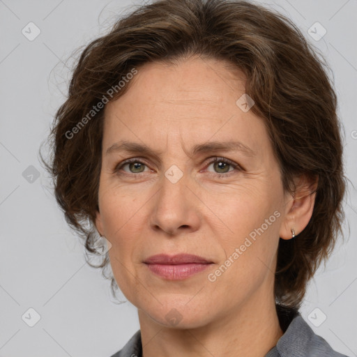 Joyful white adult female with medium  brown hair and grey eyes