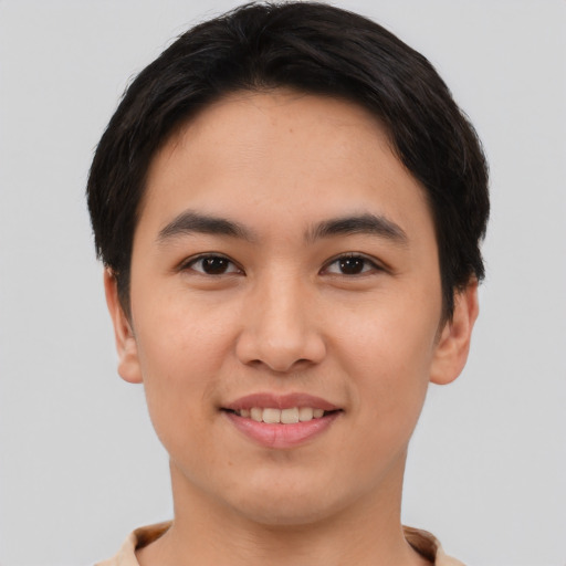 Joyful asian young-adult male with short  brown hair and brown eyes