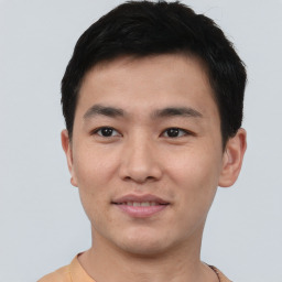 Joyful asian young-adult male with short  brown hair and brown eyes