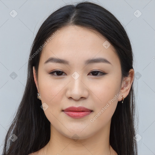 Joyful asian young-adult female with long  brown hair and brown eyes