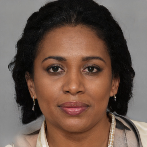Joyful black adult female with short  brown hair and brown eyes