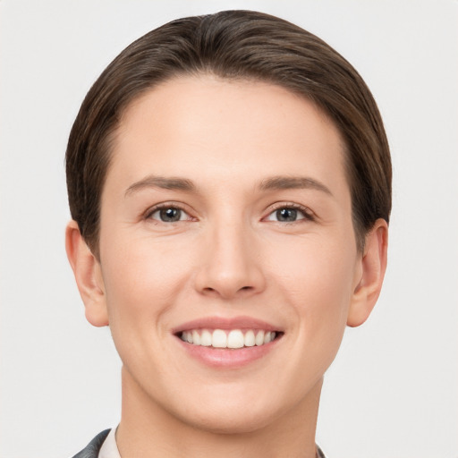 Joyful white young-adult female with short  brown hair and grey eyes