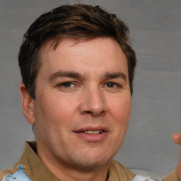 Joyful white adult male with short  brown hair and brown eyes