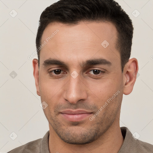 Joyful white young-adult male with short  brown hair and brown eyes