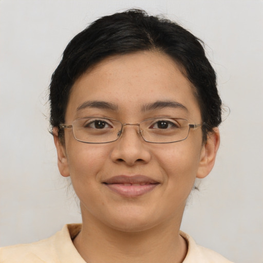 Joyful latino young-adult female with short  brown hair and brown eyes