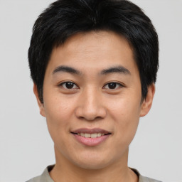 Joyful asian young-adult male with short  brown hair and brown eyes