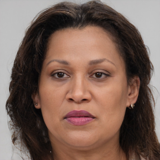 Joyful white adult female with long  brown hair and brown eyes