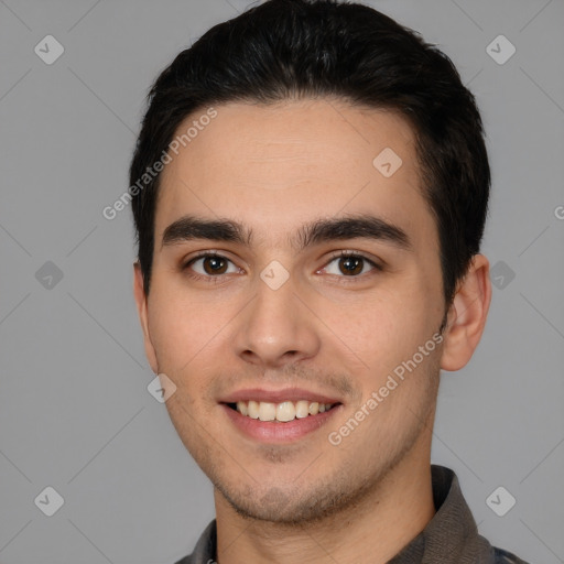 Joyful white young-adult male with short  black hair and brown eyes