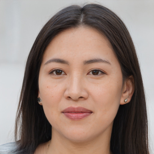 Joyful asian young-adult female with long  brown hair and brown eyes