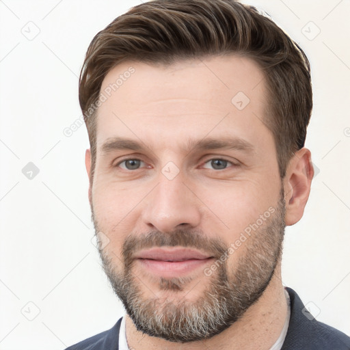 Joyful white adult male with short  brown hair and brown eyes