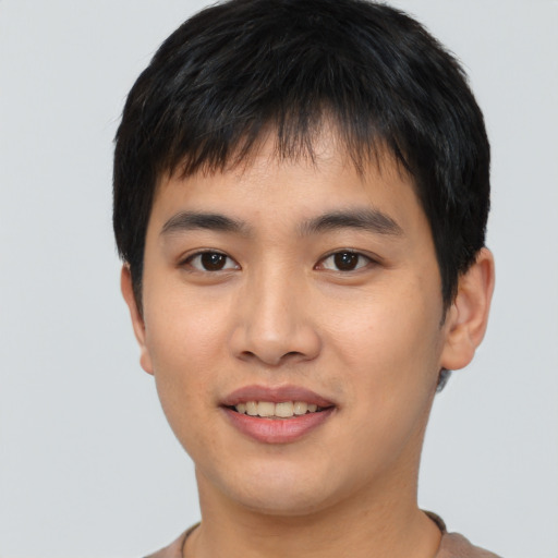 Joyful asian young-adult male with short  brown hair and brown eyes