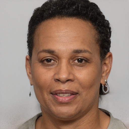 Joyful black adult female with short  brown hair and brown eyes