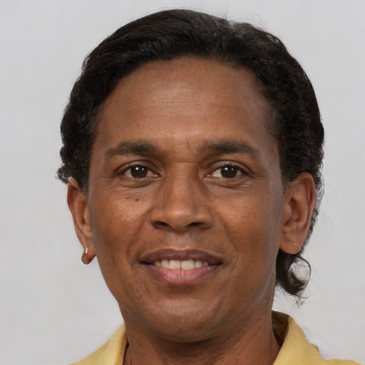 Joyful latino adult male with short  brown hair and brown eyes