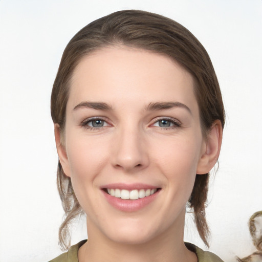 Joyful white young-adult female with medium  brown hair and grey eyes