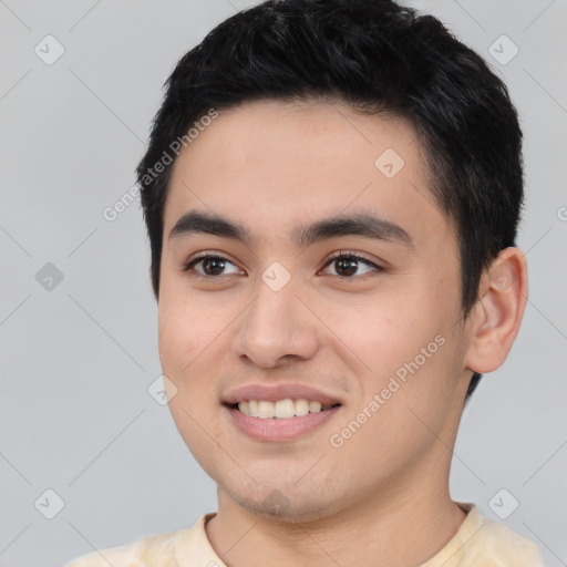 Joyful white young-adult male with short  black hair and brown eyes