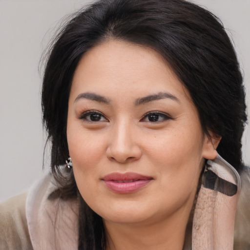Joyful asian young-adult female with long  brown hair and brown eyes