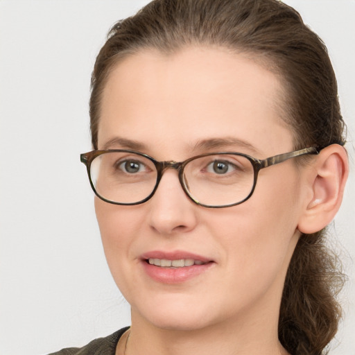 Joyful white young-adult female with medium  brown hair and blue eyes