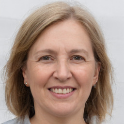 Joyful white adult female with medium  brown hair and grey eyes