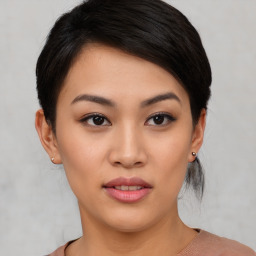 Joyful asian young-adult female with short  black hair and brown eyes