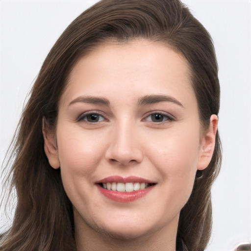 Joyful white young-adult female with long  brown hair and grey eyes