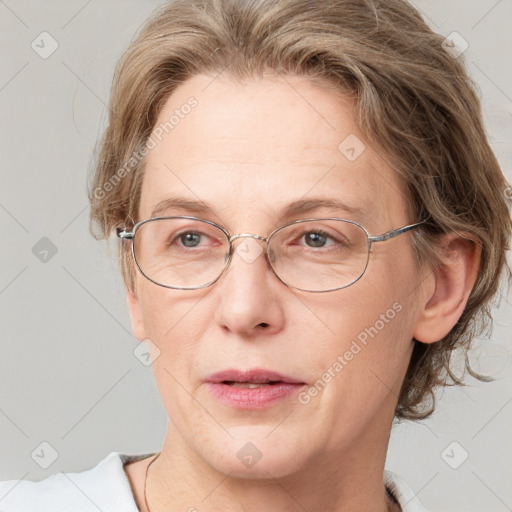 Joyful white adult female with medium  brown hair and grey eyes