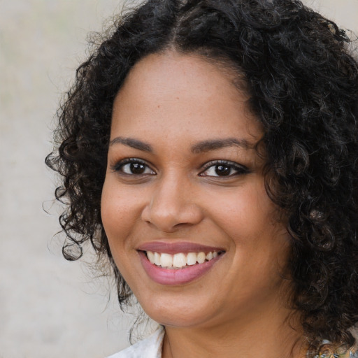 Joyful black young-adult female with medium  black hair and brown eyes