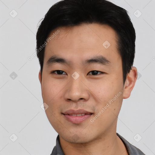 Joyful asian young-adult male with short  black hair and brown eyes