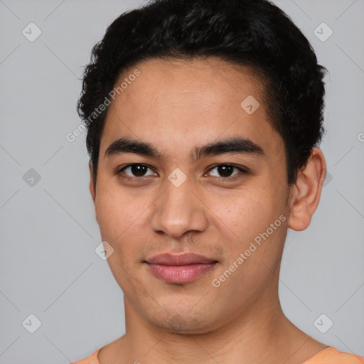 Joyful white young-adult male with short  black hair and brown eyes