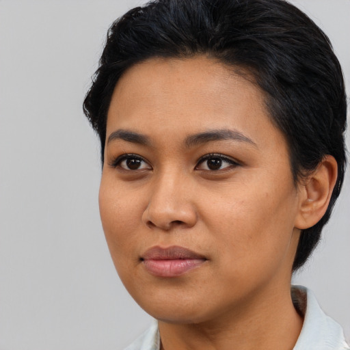 Joyful asian young-adult female with medium  black hair and brown eyes