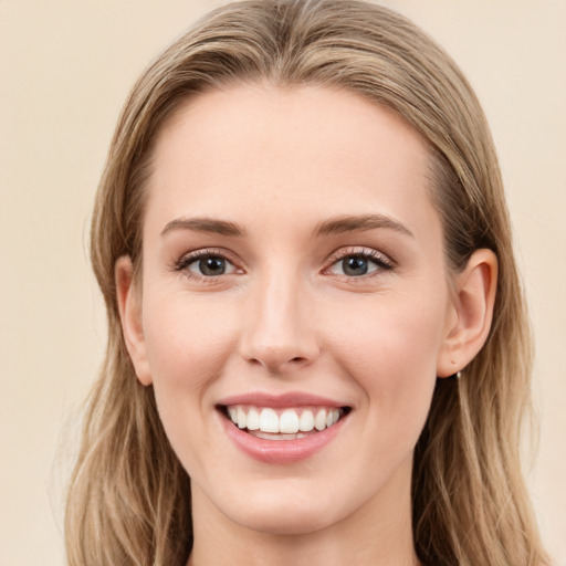 Joyful white young-adult female with long  brown hair and blue eyes