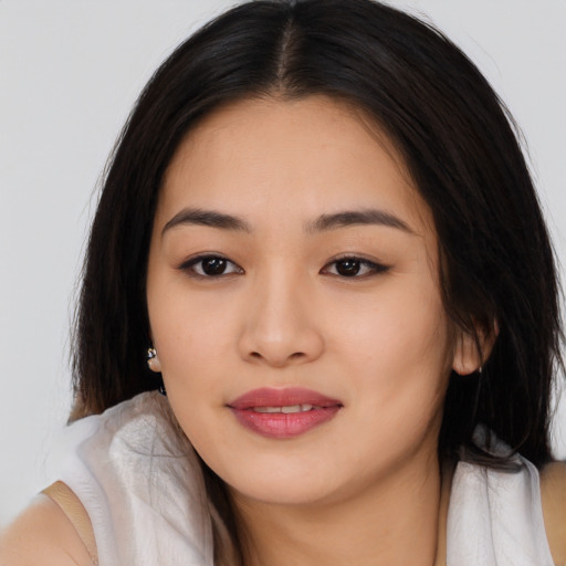 Joyful asian young-adult female with long  brown hair and brown eyes