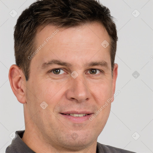 Joyful white adult male with short  brown hair and brown eyes