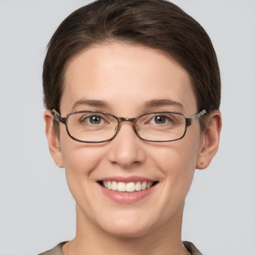 Joyful white young-adult female with short  brown hair and grey eyes