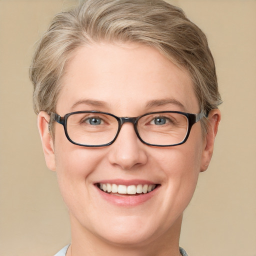 Joyful white adult female with short  brown hair and blue eyes