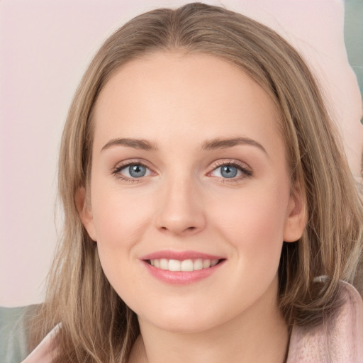 Joyful white young-adult female with long  brown hair and blue eyes