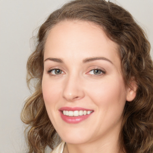 Joyful white young-adult female with medium  brown hair and green eyes