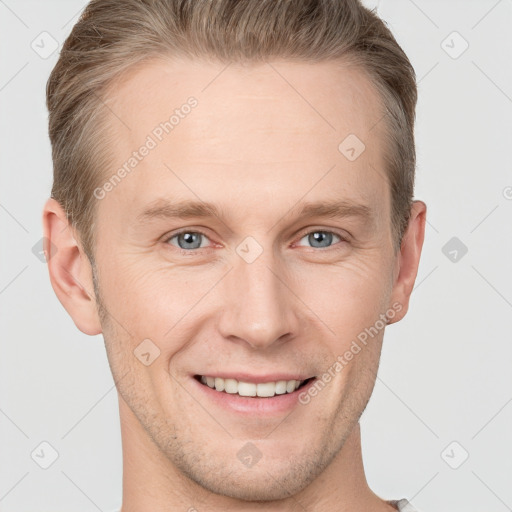 Joyful white young-adult male with short  brown hair and grey eyes