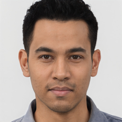 Joyful asian young-adult male with short  black hair and brown eyes