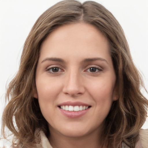 Joyful white young-adult female with long  brown hair and green eyes